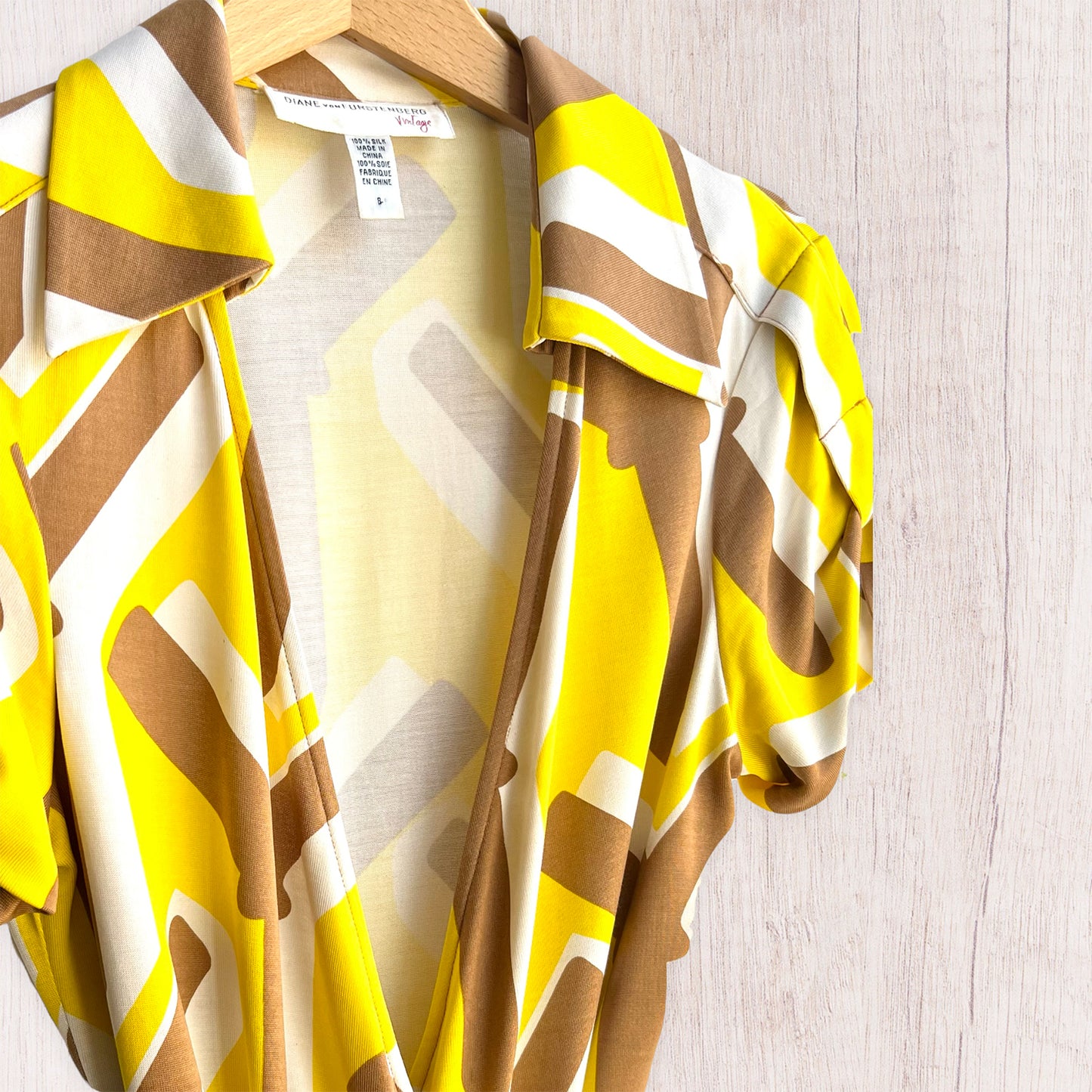 Diane Von Furstenberg yellow graphic silk wrap top brand detail